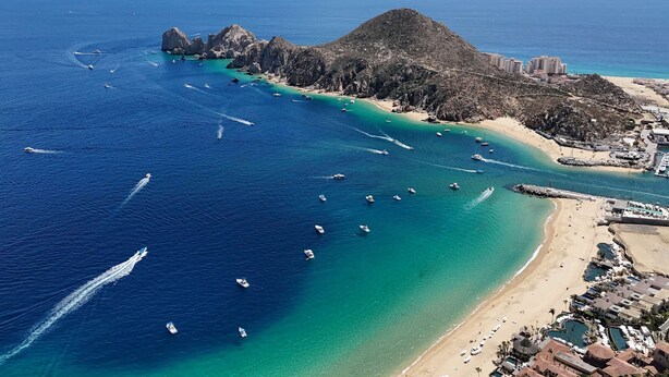 Zona costera con barcos, una playa y edificios.