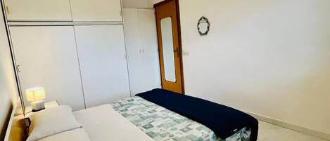 Tabla de planchar con plancha y ropa de cama