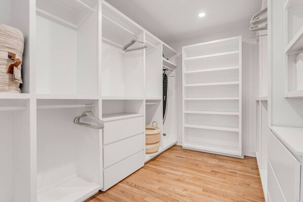 A walk-in closet with open shelves, hanging space, and a wooden floor. - Whiskey Hollow Luxury Escape on 5 Acres, Sleeps 8 (Franklin)