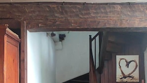 A wooden staircase with a heart-shaped decoration on the wall.