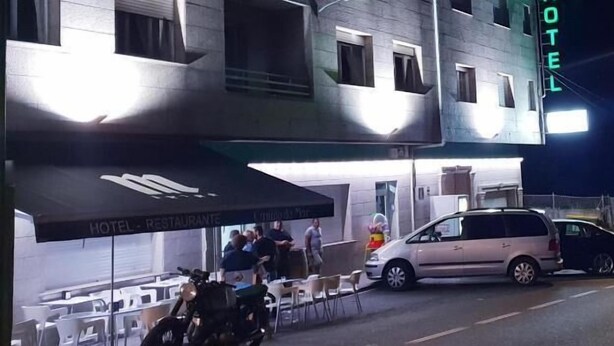 A hotel with a modern design, featuring multiple windows and a neon sign. - My Rooms Hotel Camiño do Mar (Rois)