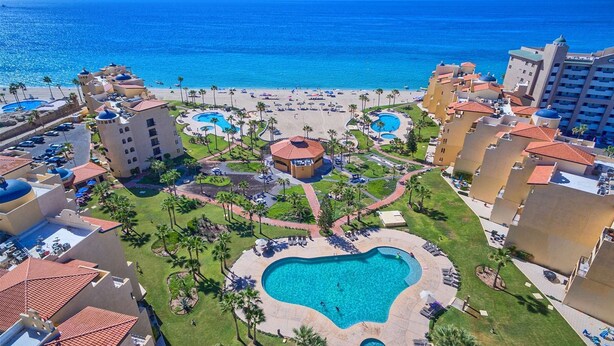 A resort with multiple swimming pools, a beach, and a central building with a dome. - Comfy & Updated 4th Floor Condo Princesa E-401 (Puerto Peñasco)