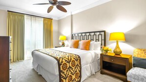A hotel room with a large bed, two bedside tables with lamps, a ceiling fan, and a window with curtains. - Honua Kai 4 Free Rental Cars KBM Resorts Grand Suite 4 Units, 9 Bedrooms HK Ml-2663 (Kaanapali)