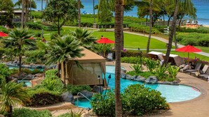 A resort pool area with palm trees, lounge chairs, and a view of the ocean. - Honua Kai 4 Free Cars KBM Resorts Front Alii Suite 4 Units, 8 Bedrooms HK Ml-3149 (Kaanapali)