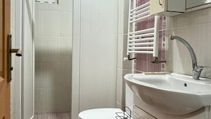 A bathroom with a toilet, sink, and shower. - Lotus Suite Otel (Balıkesir)
