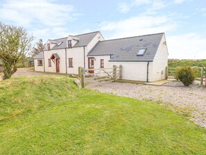 A two-story house with a sloped roof, a front door, and a small porch. - Maerdy Cwtch (Haverfordwest)