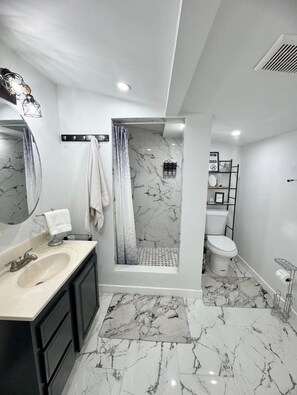 Shower, hair dryer, towels, toilet paper