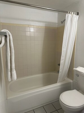Combined shower/bathtub, towels, toilet paper