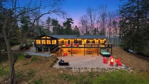 A two-story lodge with a covered patio, outdoor seating, and a fire pit. - Biltmore Ridgetop Escape | Hot Tub + Sauna (Asheville)