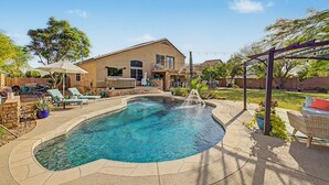 A backyard with a swimming pool, lounge chairs, a hot tub, and a pergola. - Private Pool Near Thunderbird Park (Glendale)