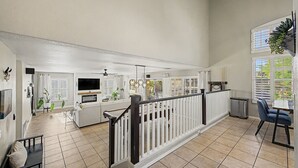 A spacious living area with a fireplace, a dining area, and a kitchen. - Private Pool Near Thunderbird Park (Glendale)