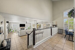 A spacious living area with a fireplace, a dining area, and a kitchen. - Private Pool Near Thunderbird Park (Glendale)