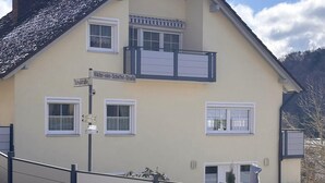 A two-story building with a gabled roof, a balcony on the upper floor, and a sign indicating 'Viktor-von-Scheffel-Strasse.' - Fruntz Vacation Rental – A Family-Friendly Getaway in Franconian Switzerland 🏡🌳 (Gößweinstein)