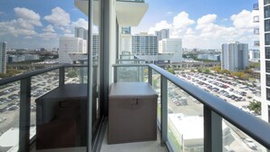 A balcony with a city view, a glass door, and a small seating area. - C1611 - Modern Boho Retreat with Pool & City Views in Miami Downtown (Miami)