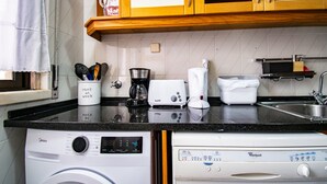 A kitchen with a dishwasher, a coffee maker, a toaster, and a sink. - Parede Coastal Family Retreat (Cascais)