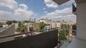 A high-rise building with a view of a cityscape, including several modern buildings and a clear sky. - Shortstaypoland Mokotowska (Warsaw)
