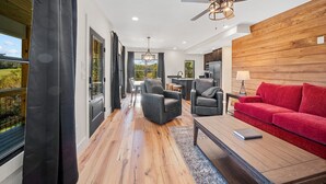 Ein modernes Wohnzimmer mit einem roten Sofa, einem Couchtisch und einem Kamin.