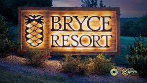 A wooden sign with 'Bryce Resort' and a pineapple logo. - Rebecca's Ark | Hot tub & smokeless fire pit! (Basye)