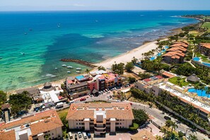 A coastal hotel with multiple buildings, a beach, and clear blue waters. - Casa Petosa - El Anclote | 2BR/2BA Punta Mita, ocean view, pool, beach access (Punta Mita)