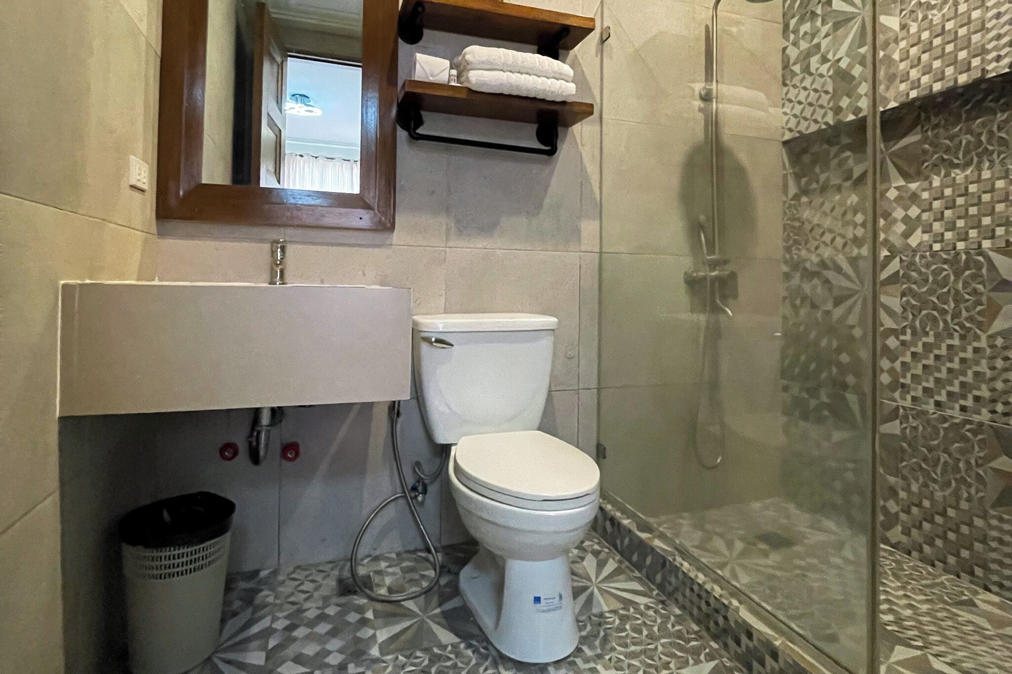 A bathroom with a toilet, sink, and shower.