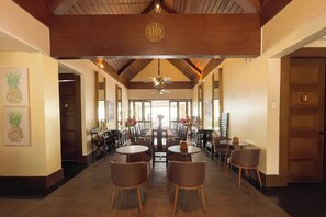 A hotel lobby with a long dining area, wooden ceiling beams, and a central chandelier. - Windy Ridge Hotel Tagaytay (Tagaytay)