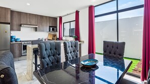 A modern kitchen with dark wood cabinets, a stainless steel refrigerator, and a microwave. - 3BR/2.5BA Porto Residencial in Nuevo Nayarit, near ocean, pool, patio, WiFi (Nuevo Vallarta)
