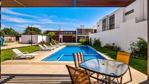 A swimming pool with lounge chairs, a table, and a pergola. - 3BR/2.5BA Porto Residencial in Nuevo Nayarit, near ocean, pool, patio, WiFi (Nuevo Vallarta)
