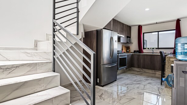 A modern kitchen with a stainless steel refrigerator, a microwave, and a water dispenser. - 3BR/2.5BA Porto Residencial in Nuevo Nayarit, near ocean, pool, patio, WiFi (Nuevo Vallarta)
