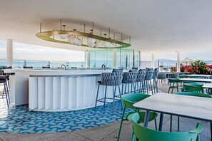 Outdoor dining - Ocean-view condo with balcony, central AC, pool, gym, cinema, & bar (Nuevo Vallarta)