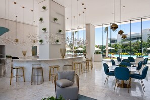 Outdoor dining - Stylish ocean-view condo with pool, gym, private balcony, AC, & WiFi (Nuevo Vallarta)