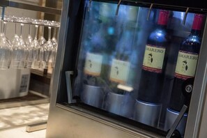 A wine cooler with bottles labeled 'MARERO' and a rack of wine glasses. - Hotel Forza Oita (Oita)