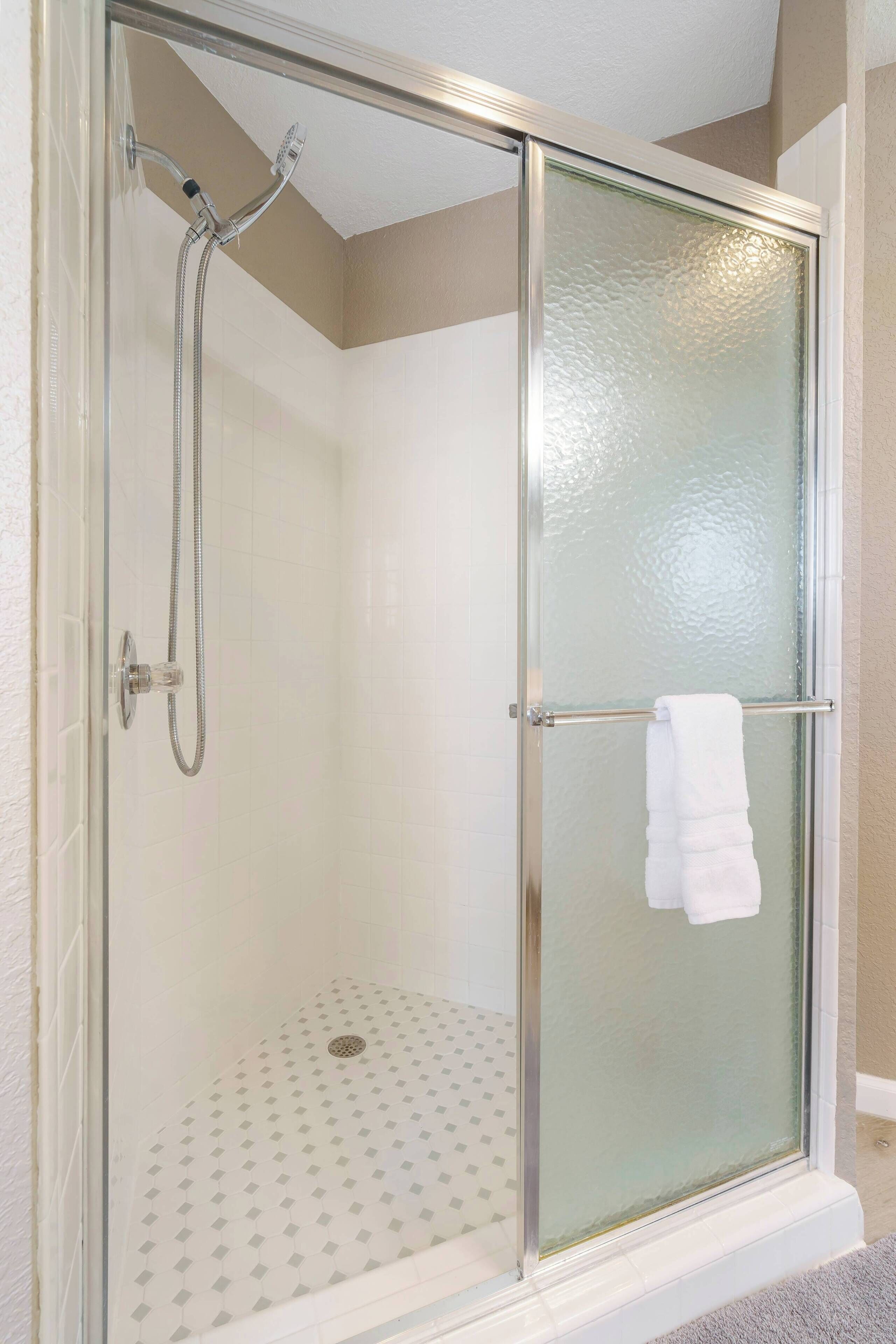 Shower, hair dryer, towels, shampoo