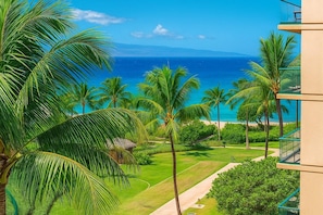 A tropical resort with a view of the ocean, palm trees, and a pathway leading to the beach. - Honua Kai | Ocean View 5 BR, Sleeps 16 | Car Incl. w/ 6+ Nights | HKH ML-2855 by KBM (Lahaina)