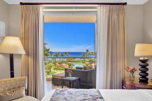A hotel room with a bed, a chair, a small table with a vase of flowers, and a view of a pool and palm trees. - KBM Resorts | 4 FREE CARS | Honua Kai Hokulani | Ocean view | 8-Bedroom Multi-Unit Listing Recently Remodeled! HK ML-2894 (Lahaina)
