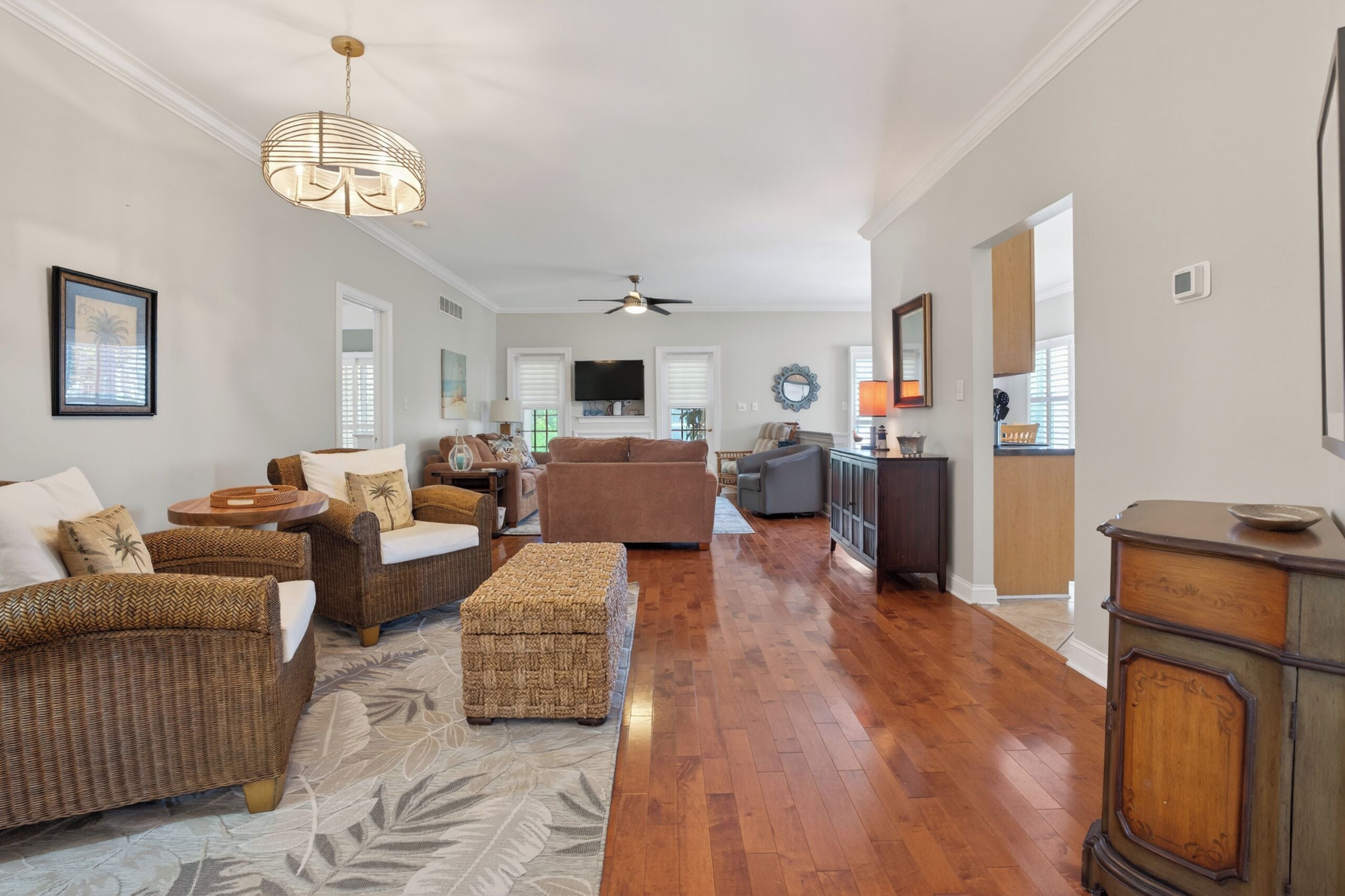 A spacious living room with a large sofa, a coffee table, and a television.
