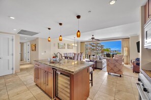A spacious kitchen with a central island, pendant lighting, and a view to the outside. - 2 Honua Kai Villas | Ocean Front | Sleeps 14 | Free Car w/ 6+ Nights | ML-2951 (Lahaina)