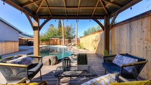 A covered outdoor area with a pool, wooden deck, and seating. - The PALMERA House with Private Pool Oasis, 3BR, Near Galleria Sacramento (Sacramento)