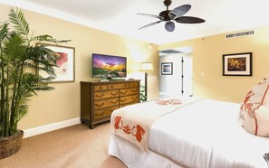 A bedroom with a bed, a ceiling fan, a dresser, a TV, and a plant. - 2 Honua Kai Villas | Ocean Front | Sleeps 14 | Free Car w/ 6+ Nights | ML-3074 (Lahaina)