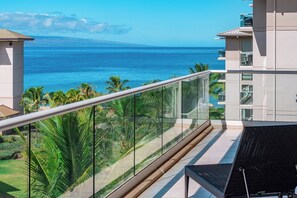 A balcony with a view of the ocean and palm trees. - Honua Kai | Ocean View 5 BR, Sleeps 14 | Car Incl. w/ 6+ Nights | HKH ML-3074 by KBM (Lahaina)
