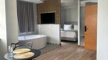 Deluxe Room | Down comforters, in-room safe, individually furnished, blackout drapes
