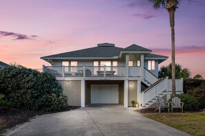 A two-story house with a covered garage, a balcony, and a staircase leading to the upper level. - Steps to Beach + Pool Access (Isle Of Palms)