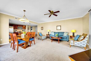 A living room with a dining table, chairs, a sofa, and a ceiling fan. - 2 Honua Kai Villas | Ocean Front | Sleeps 12 | Free Car w/ 6+ Nights | ML-3242 (Lahaina)