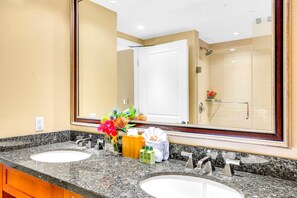 A bathroom with two sinks, a large mirror, and a shower. - Honua Kai | Ocean View 7 BR, Sleeps 24 | Car Incl. w/ 6+ Nights | HKK ML-3269 by KBM (Lahaina)