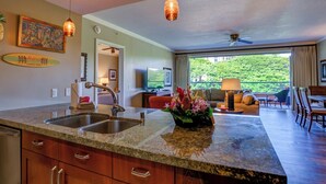 A modern kitchen with granite countertops, stainless steel appliances, and pendant lighting. - Honua Kai | Ocean View 7 BR, Sleeps 24 | Car Incl. w/ 6+ Nights | HKK ML-3287 by KBM (Lahaina)