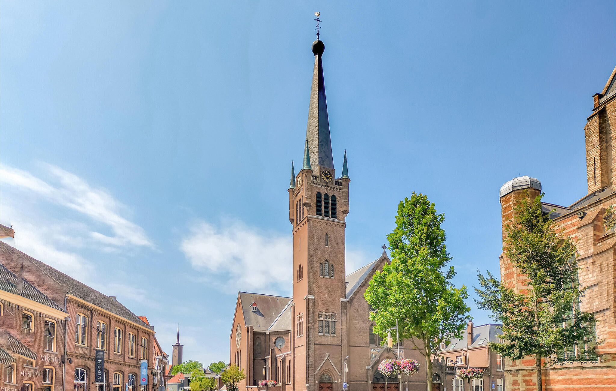 A historic church with a tall spire, a clock tower, and a prominent steeple.