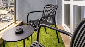 A balcony with two chairs, a small table, and a view of the cityscape. - A2 Modern 1-bed Apartment 2 (Plovdiv)