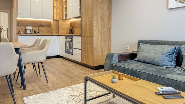 A modern living space with a kitchen, dining area, and a sofa. - A2 Modern 1-bed Apartment 2 (Plovdiv)
