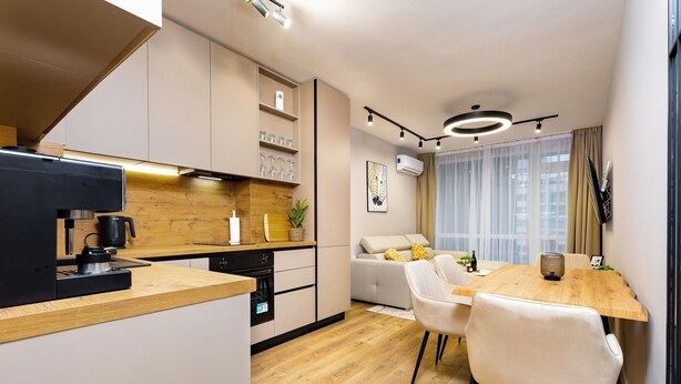 A modern kitchen with a coffee machine, wooden countertop, and built-in cabinets. - A2 Modern 1-bed Apartment 1 (Plovdiv)