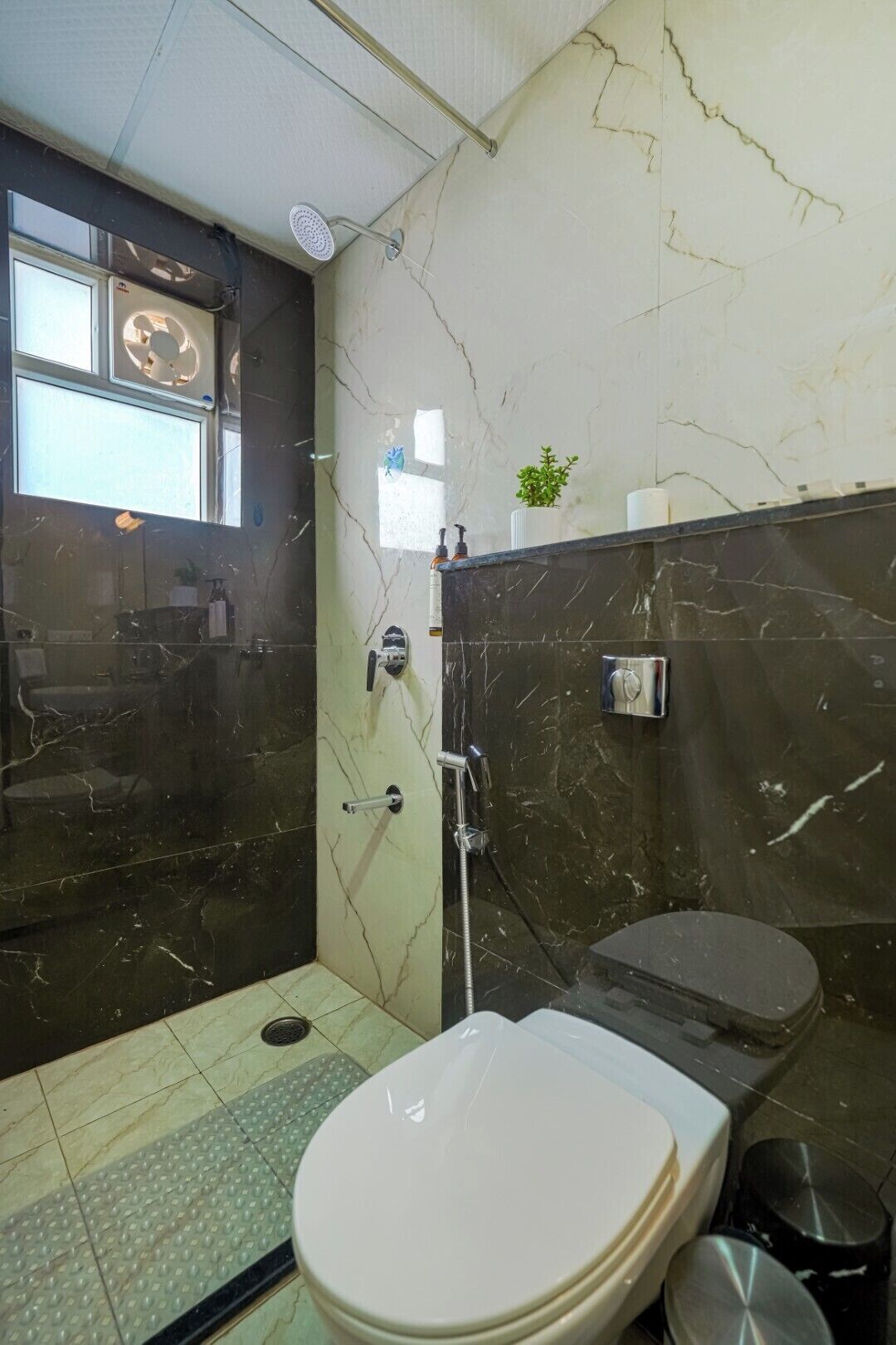A bathroom with a toilet, bidet, and a shower area.