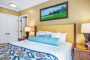 A hotel room with a bed, a nightstand, a lamp, a picture on the wall, and a door. - Honua Kai | Ocean View 7 BR, Sleeps 20 | Car Incl. w/ 6+ Nights | HKK ML-3416 by KBM (Lahaina)